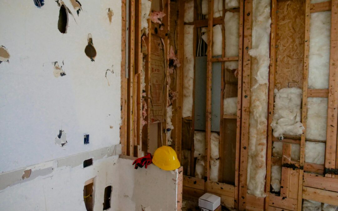 Couple reviewing a home remodeling checklist with a contractor in a modern Aptos, CA kitchen renovation project.