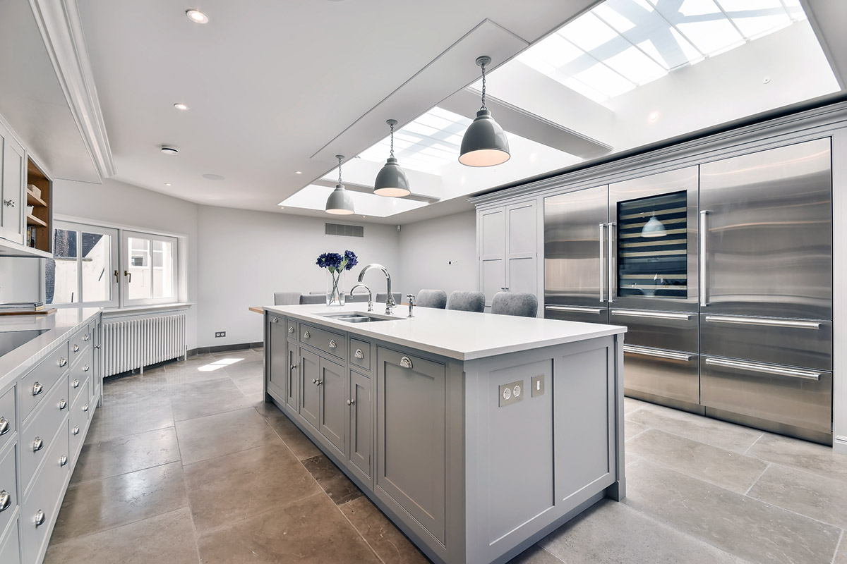 A minimalist kitchen with skylight over island.