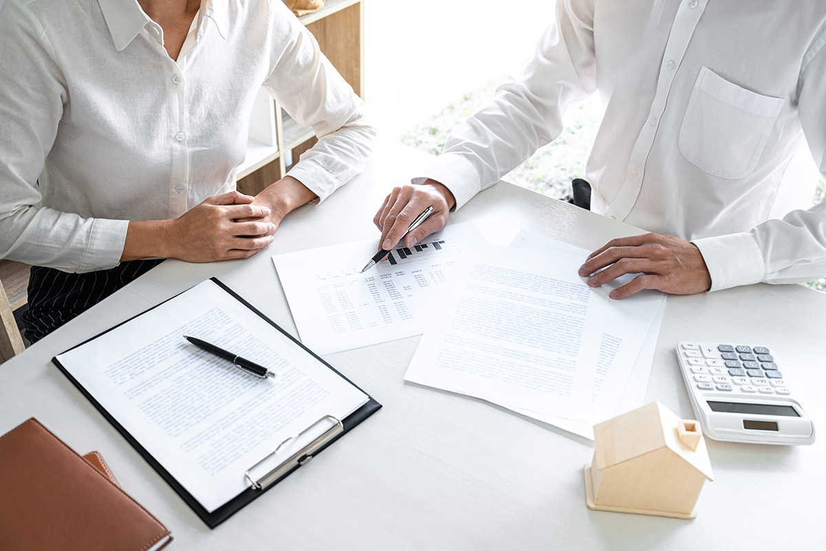 agent with client at desk setting fee